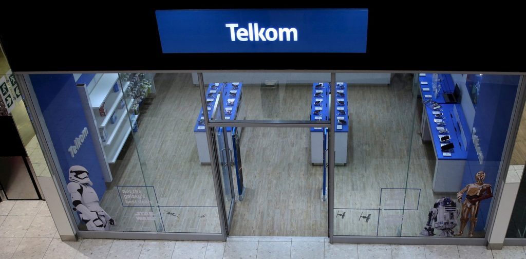 A shopper walks past a Telkom shop at a mall in Johannesburg