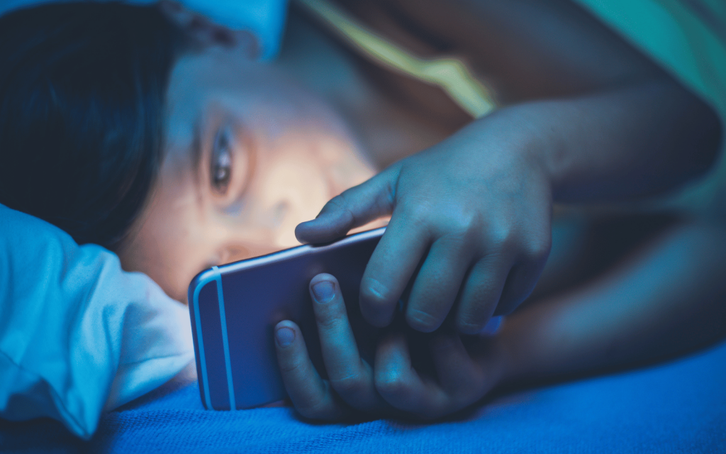 Technology reading phone in bed