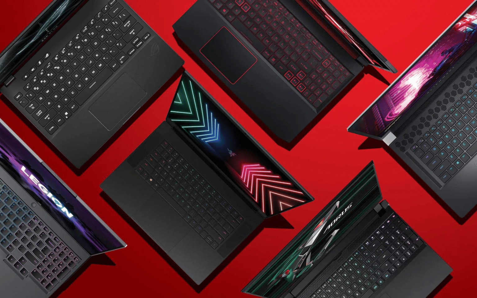 An assortment of gaming laptops on a red background