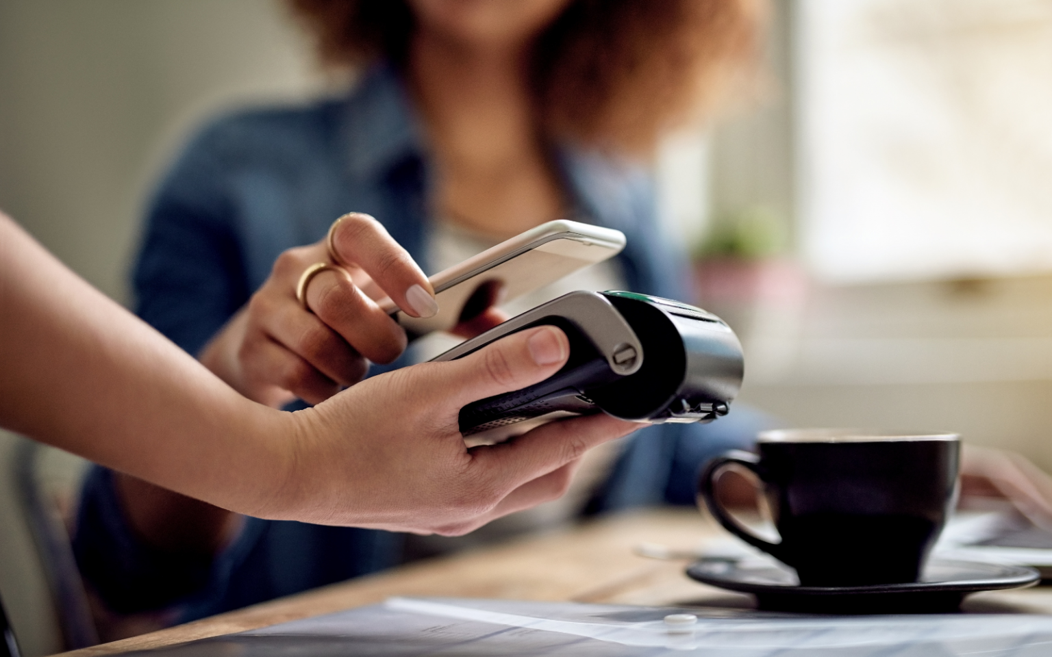 tap-to-pay smartphone header (Apple Pay, Bank Zero)