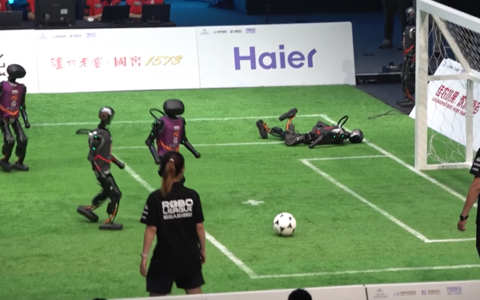 Watching these bumbling robots play football is probably the most fun you’ll have today Robot footballers header
