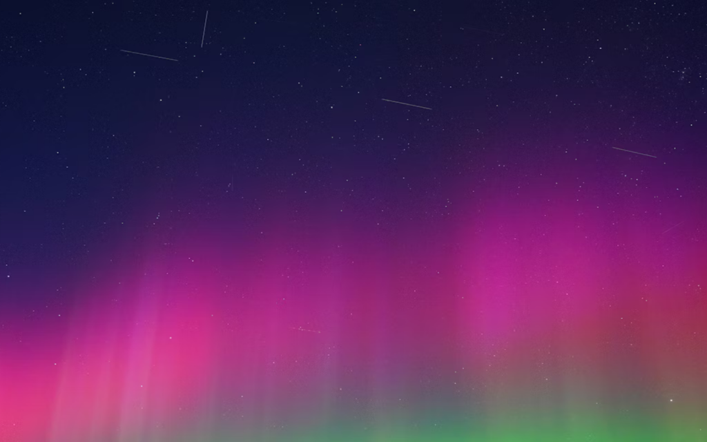 A Starlink train passing through auroras over rural Saskatchewan in November 2025 header