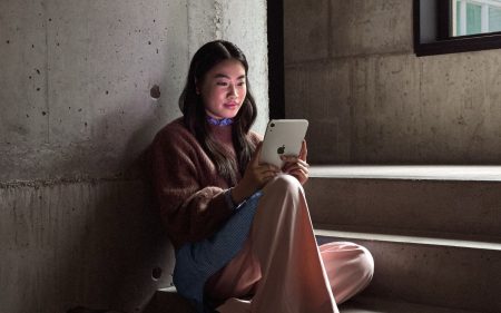 Apple announces the ‘new’ iPad Mini Lady using the iPad Mini on stone steps